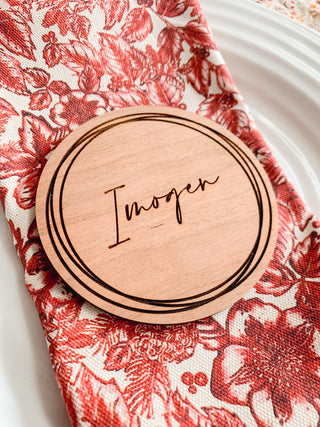 Script font on cherry wood place setting.