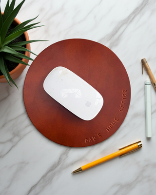 Tan leather mouse mat with Dad's Home Office stamped on it.