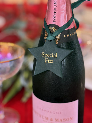 Pink champagne bottle with 'Special Fizz' tag and 'Fortnum & Mason' branding.