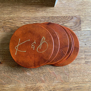 Best selling leather coasters with couples initials applied on in gold. Available in tan, brown or mahogany.