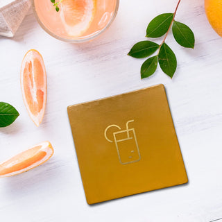 Leather coasters complete with favourite drink applied on the coaster in gold. Yellow square coaster with mojito symbol.