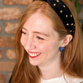 Glittery blue art deco earring on a happy redhead.